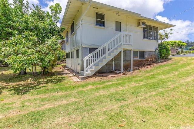 101 Kawananakoa Pl, Honolulu, HI 96817 - back of property featuring stairs, a lawn, and a wall unit AC