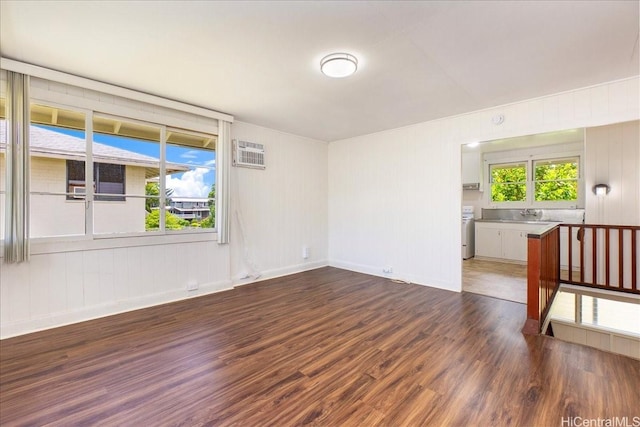 101 Kawananakoa Pl, Honolulu, HI 96817 - spare room featuring dark wood-style floors, plenty of natural light, and an AC wall unit