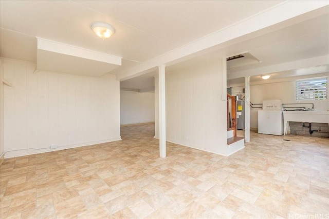 101 Kawananakoa Pl, Honolulu, HI 96817 - below grade area with washer / clothes dryer, wood walls, and electric water heater