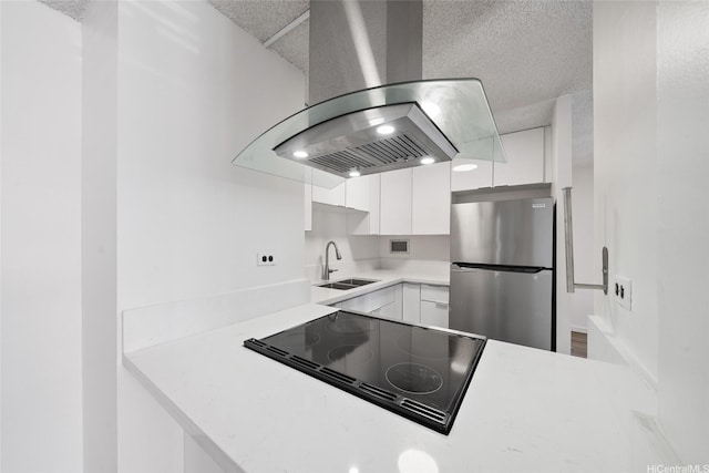 1535 Pensacola St Unit 208, Honolulu, HI 96822 - kitchen featuring freestanding refrigerator, ventilation hood, stovetop with downdraft, white cabinets, and light countertops
