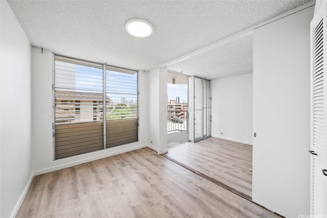 1535 Pensacola St Unit 208, Honolulu, HI 96822 - unfurnished room featuring a textured ceiling and wood finished floors