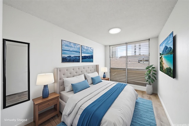 1535 Pensacola St Unit 208, Honolulu, HI 96822 - bedroom with wood finished floors and a textured ceiling