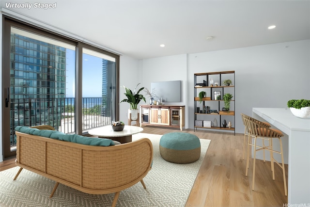 987 Queen St Unit 1512, Honolulu, HI 96814 - living area featuring light wood-style flooring, expansive windows, and recessed lighting