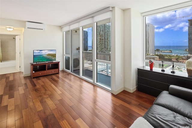 909 Kapiolani Blvd Unit 2002, Honolulu, HI 96814 - living room with expansive windows, an AC wall unit, wood finished floors, and a water view