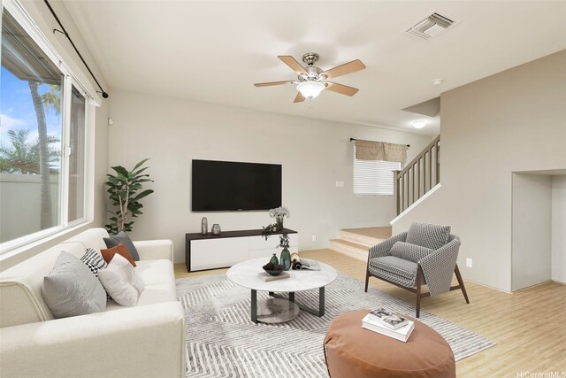 91-1200 Keaunui Dr Unit 208, Ewa Beach, HI 96706 - living area with stairs, light wood-style floors, and a ceiling fan