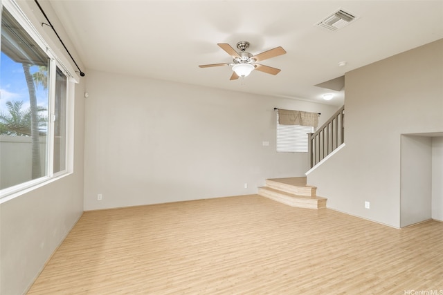 91-1200 Keaunui Dr Unit 208, Ewa Beach, HI 96706 - unfurnished room featuring wood finished floors, stairway, and a ceiling fan