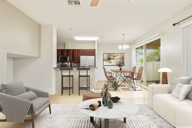 91-1200 Keaunui Dr Unit 208, Ewa Beach, HI 96706 - living room featuring light wood-style floors, a chandelier, and ceiling fan