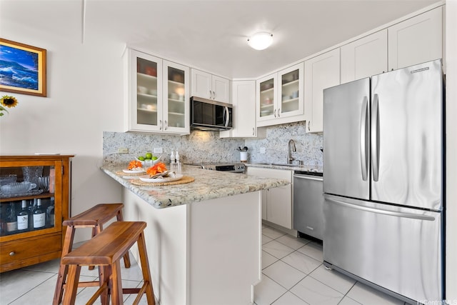 411 Hobron Ln Unit 3801, Honolulu, HI 96815 - kitchen featuring stainless steel appliances, light tile patterned floors, backsplash, and a peninsula