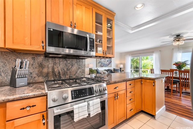 4845 Sierra Dr, Honolulu, HI 96816 - kitchen featuring stainless steel appliances, a peninsula, light tile patterned floors, tasteful backsplash, and crown molding