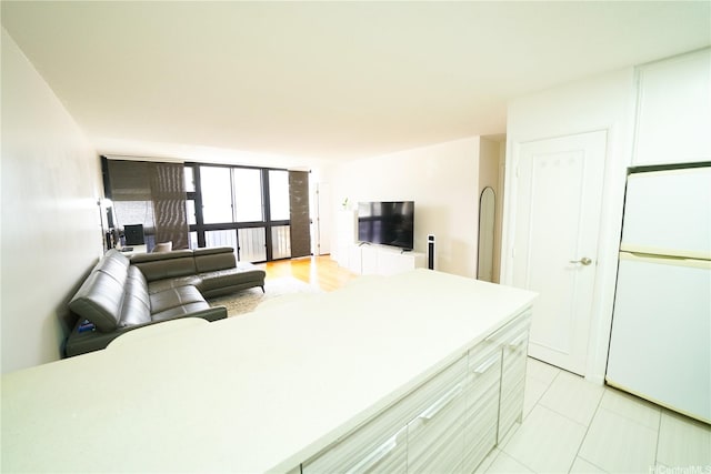 827 Kinau St Unit D703, Honolulu, HI 96813 - kitchen with refrigerator, open floor plan, light countertops, light tile patterned floors, and white cabinets