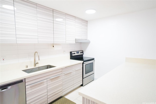 827 Kinau St Unit D703, Honolulu, HI 96813 - kitchen featuring appliances with stainless steel finishes, under cabinet range hood, backsplash, modern cabinets, and light countertops