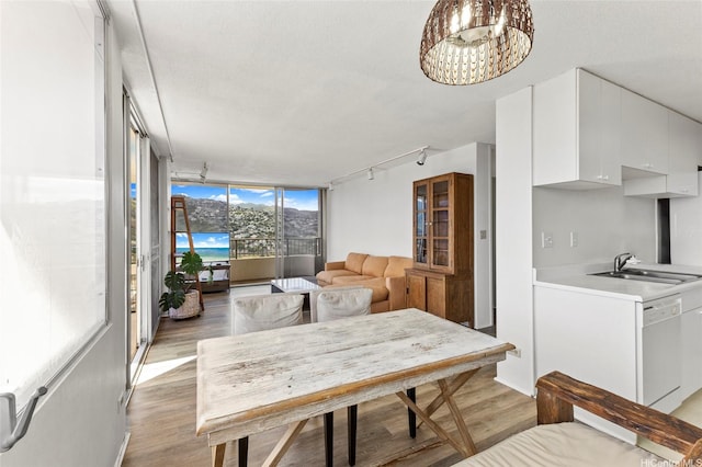 2825 S King St Unit 2504, Honolulu, HI 96826 - dining area with track lighting, light wood-style flooring, floor to ceiling windows, and a chandelier