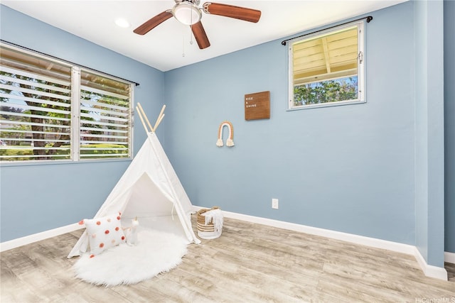 47-366 Hui Iwa St Unit 71, Kaneohe, HI 96744 - recreation room featuring healthy amount of natural light, a ceiling fan, and wood finished floors
