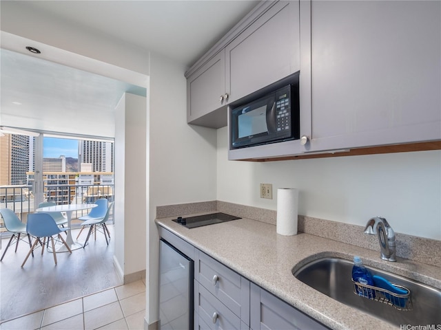 2427 Kuhio Ave Unit 1501, Honolulu, HI 96815 - kitchen featuring black appliances, gray cabinets, light countertops, and light tile patterned flooring