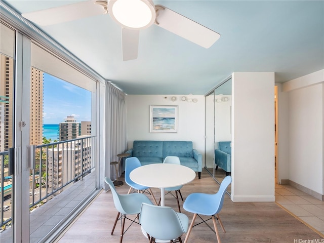 2427 Kuhio Ave Unit 1501, Honolulu, HI 96815 - dining room with a ceiling fan, wood finished floors, and a water view