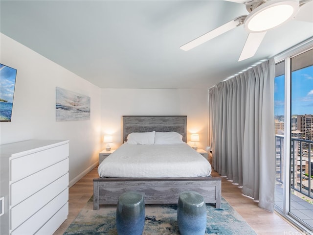 2427 Kuhio Ave Unit 1501, Honolulu, HI 96815 - bedroom with wood finished floors, access to exterior, floor to ceiling windows, and a ceiling fan