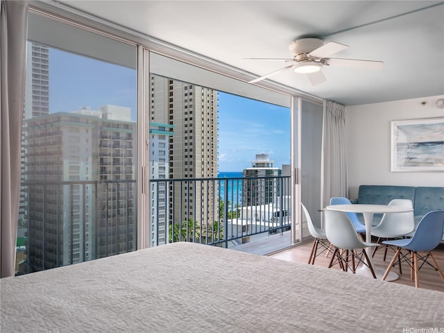 2427 Kuhio Ave Unit 1501, Honolulu, HI 96815 - bedroom with floor to ceiling windows, access to outside, wood finished floors, a view of city, and ceiling fan