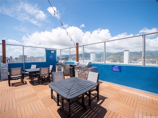 2427 Kuhio Ave Unit 1501, Honolulu, HI 96815 - wooden terrace featuring outdoor dining area, an outdoor kitchen, and a mountain view