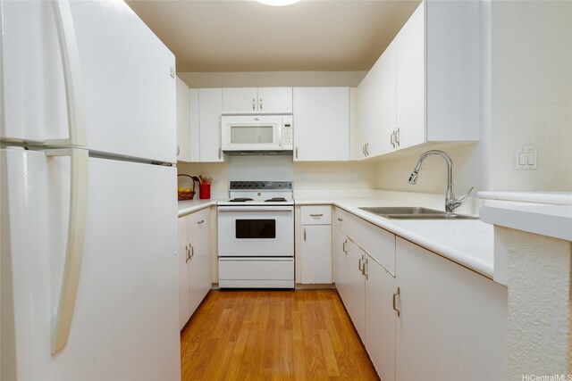 239 Mananai Pl Unit 54F, Honolulu, HI 96818 - kitchen with white appliances, white cabinetry, and light countertops