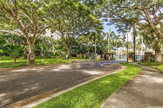 520 Lunalilo Home Rd Unit 6107, Honolulu, HI 96825 - view of asphalt road featuring a gate, curbs, and a gated entry