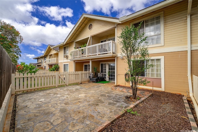 94-1465 Waipio Uka St Unit S103, Waipahu, HI 96797 - rear view of property featuring a balcony, a fenced backyard, and a patio area