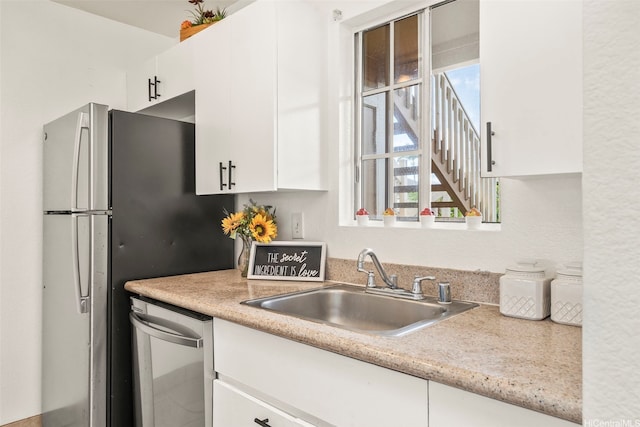94-1465 Waipio Uka St Unit S103, Waipahu, HI 96797 - kitchen with appliances with stainless steel finishes, light countertops, and white cabinetry