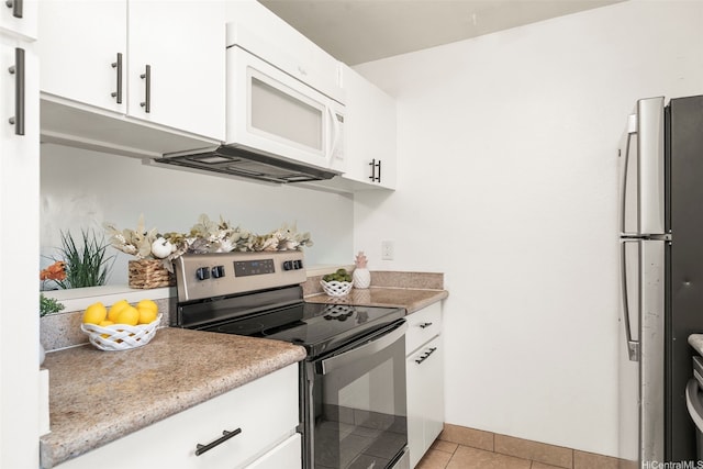 94-1465 Waipio Uka St Unit S103, Waipahu, HI 96797 - kitchen featuring stainless steel electric range oven, freestanding refrigerator, white microwave, light tile patterned floors, and light countertops