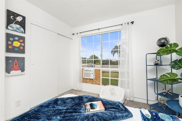 94-1465 Waipio Uka St Unit S103, Waipahu, HI 96797 - bedroom with carpet flooring, cooling unit, a textured ceiling, and a closet