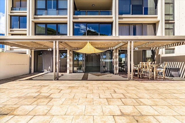 1600 Ala Moana Blvd Unit 306, Honolulu, HI 96815 - view of exterior entry with a patio and outdoor dining area