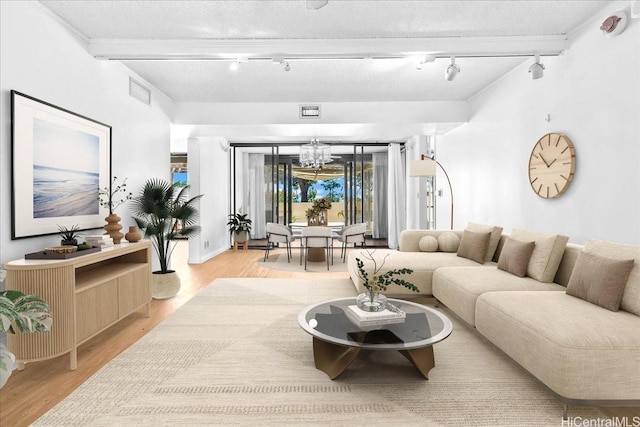 1600 Ala Moana Blvd Unit 306, Honolulu, HI 96815 - living room with rail lighting, a chandelier, and light wood-style flooring