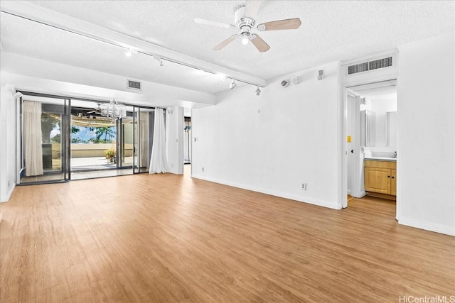 1600 Ala Moana Blvd Unit 306, Honolulu, HI 96815 - unfurnished room with light wood-style floors, a textured ceiling, a chandelier, ceiling fan, and track lighting