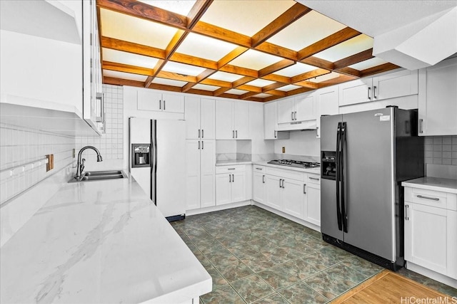 1600 Ala Moana Blvd Unit 306, Honolulu, HI 96815 - kitchen featuring appliances with stainless steel finishes, under cabinet range hood, coffered ceiling, tasteful backsplash, and light stone countertops