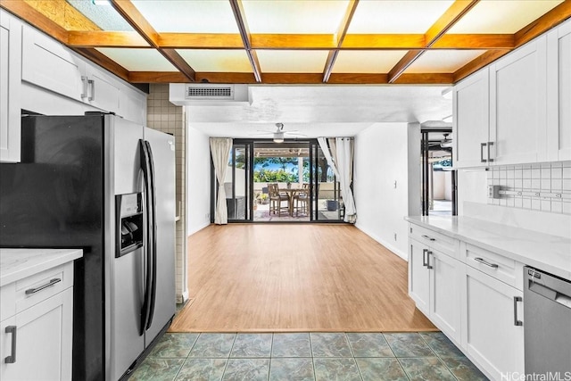 1600 Ala Moana Blvd Unit 306, Honolulu, HI 96815 - kitchen with appliances with stainless steel finishes, coffered ceiling, backsplash, white cabinets, and light stone counters