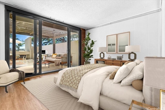 1600 Ala Moana Blvd Unit 306, Honolulu, HI 96815 - bedroom featuring wood finished floors, access to outside, and a textured ceiling
