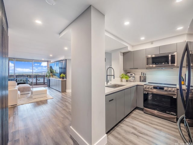 415 S St Unit 1602, Honolulu, HI 96813 - kitchen featuring gray cabinets, appliances with stainless steel finishes, modern cabinets, tasteful backsplash, and floor to ceiling windows