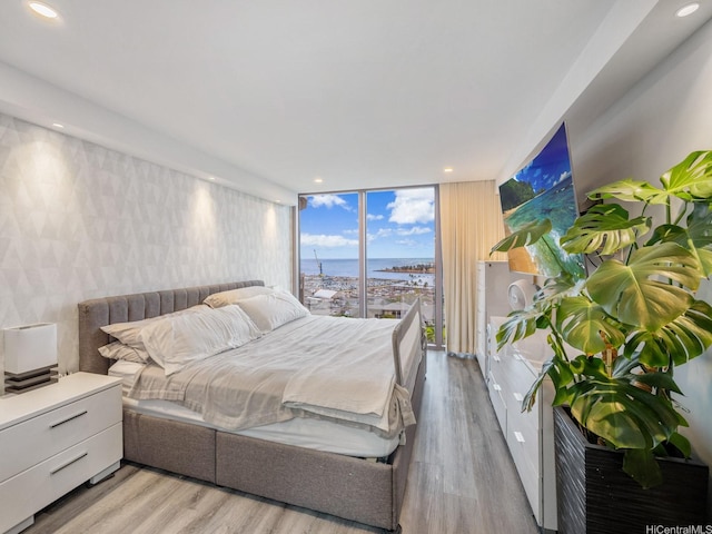 415 S St Unit 1602, Honolulu, HI 96813 - bedroom featuring light wood-style flooring, a wall of windows, and recessed lighting