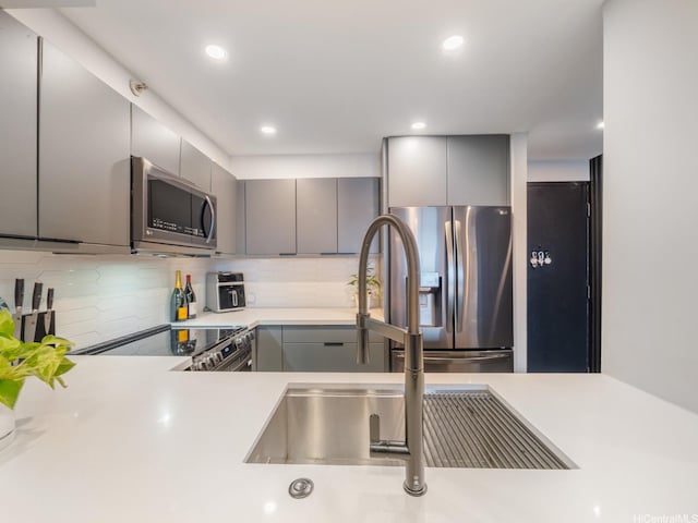 415 S St Unit 1602, Honolulu, HI 96813 - kitchen featuring appliances with stainless steel finishes, gray cabinets, light countertops, and recessed lighting