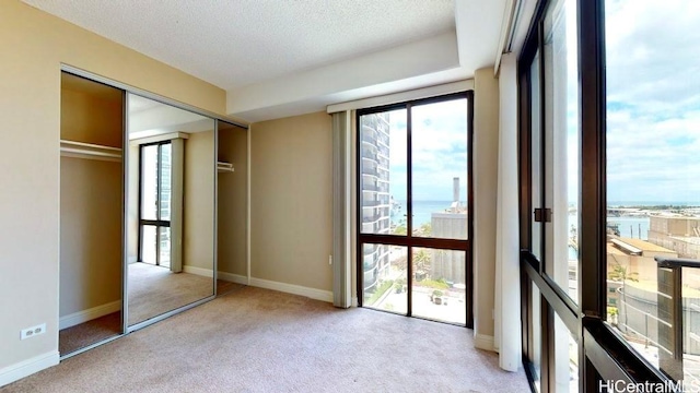 225 Queen St Unit 14A, Honolulu, HI 96813 - unfurnished bedroom featuring a water view, light colored carpet, and a closet