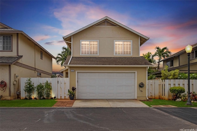 91-1017 Hoopili St Unit 66, Ewa Beach, HI 96706 - traditional-style home featuring a shingled roof, driveway, stucco siding, and an attached garage