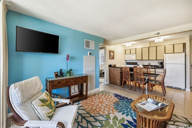 229 Paoakalani Ave Unit 1014, Honolulu, HI 96815 - living area featuring light tile patterned flooring and a textured ceiling