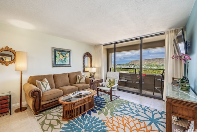 229 Paoakalani Ave Unit 1014, Honolulu, HI 96815 - living room featuring light tile patterned floors and a textured ceiling