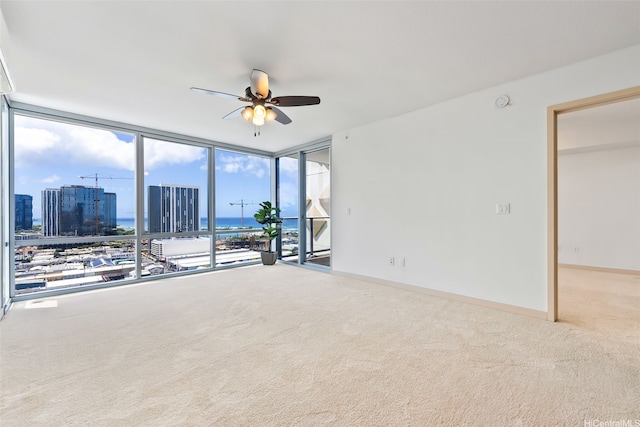 555 S St Unit 2303, Honolulu, HI 96813 - carpeted spare room featuring ceiling fan, a wall of windows, a water view, and a view of city