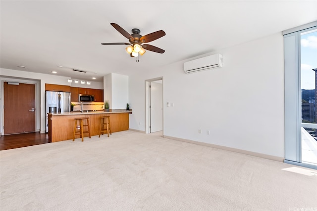 555 S St Unit 2303, Honolulu, HI 96813 - unfurnished living room featuring an AC wall unit, carpet flooring, a ceiling fan, and recessed lighting