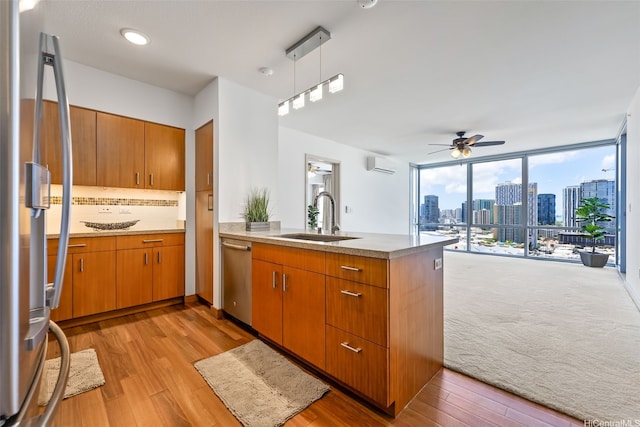 555 S St Unit 2303, Honolulu, HI 96813 - kitchen with appliances with stainless steel finishes, a peninsula, ceiling fan, light wood-type flooring, and floor to ceiling windows