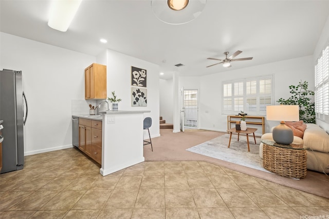 91-3082 Makalea Loop Unit 41, Ewa Beach, HI 96706 - kitchen with stainless steel appliances, open floor plan, a kitchen breakfast bar, ceiling fan, and light countertops
