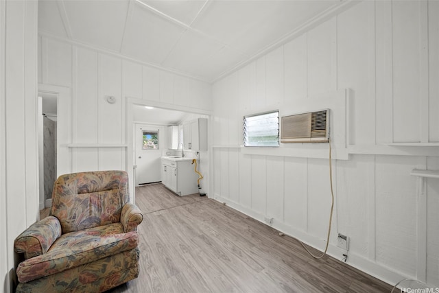 2963 Koali Rd Unit D, Honolulu, HI 96826 - sitting room with a decorative wall, a wall mounted air conditioner, light wood-style flooring, and crown molding