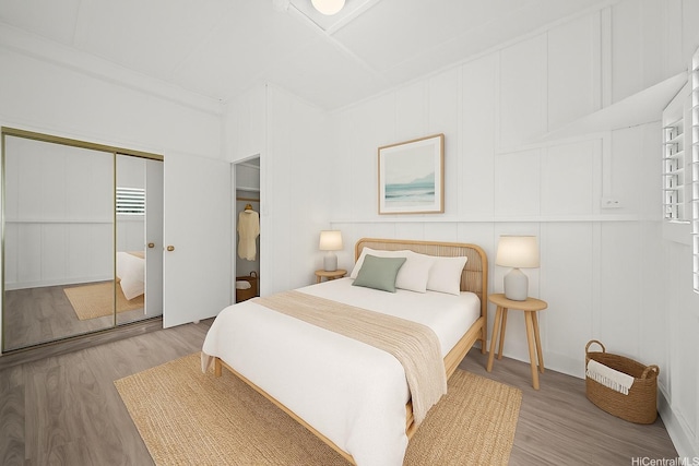 2963 Koali Rd Unit D, Honolulu, HI 96826 - bedroom featuring wood finished floors, a decorative wall, and a closet