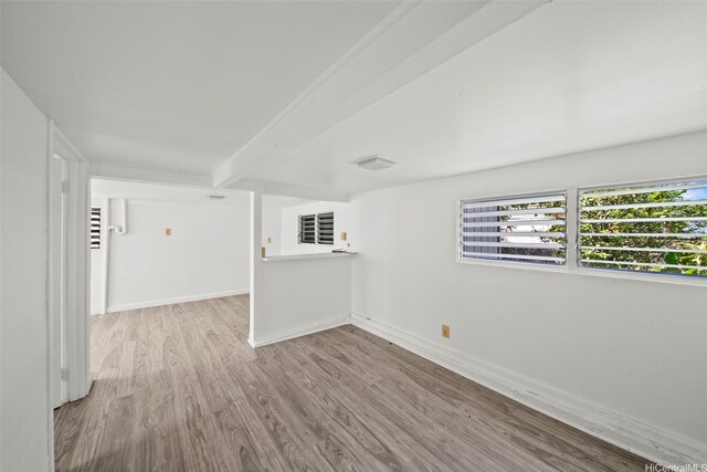 2963 Koali Rd Unit D, Honolulu, HI 96826 - empty room featuring wood finished floors and beam ceiling