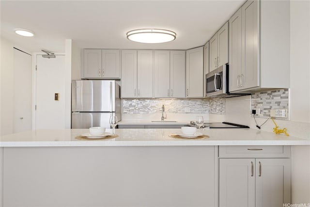 411 Hobron Ln Unit 3402, Honolulu, HI 96815 - kitchen with stainless steel appliances, light countertops, decorative backsplash, and gray cabinetry