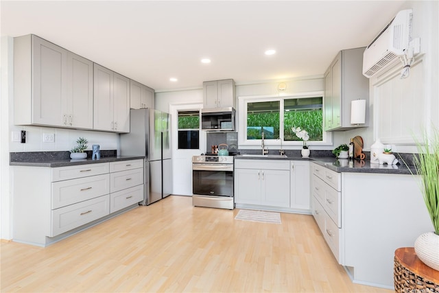 45-860 Anoi Rd Unit 5, Kaneohe, HI 96744 - kitchen featuring stainless steel appliances, light wood finished floors, a wall mounted air conditioner, gray cabinetry, and recessed lighting